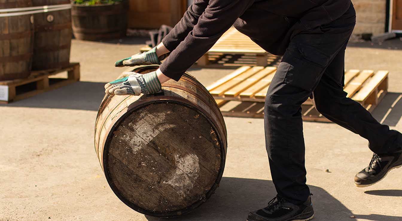 distiller rolling barrel on floor