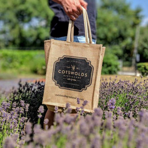 person carrying cotswolds distillery shopping bag